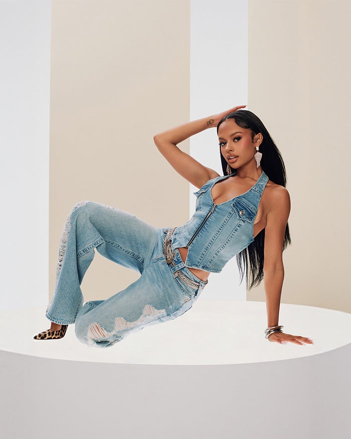 Woman wearing a true religion denim vest with true religion light wash ripped jeans and cheetah print heels
