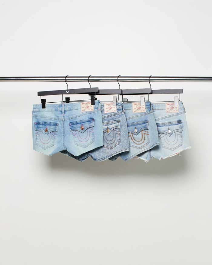 True religion jean shorts with horseshoe stitching on the back pockets on hangers 