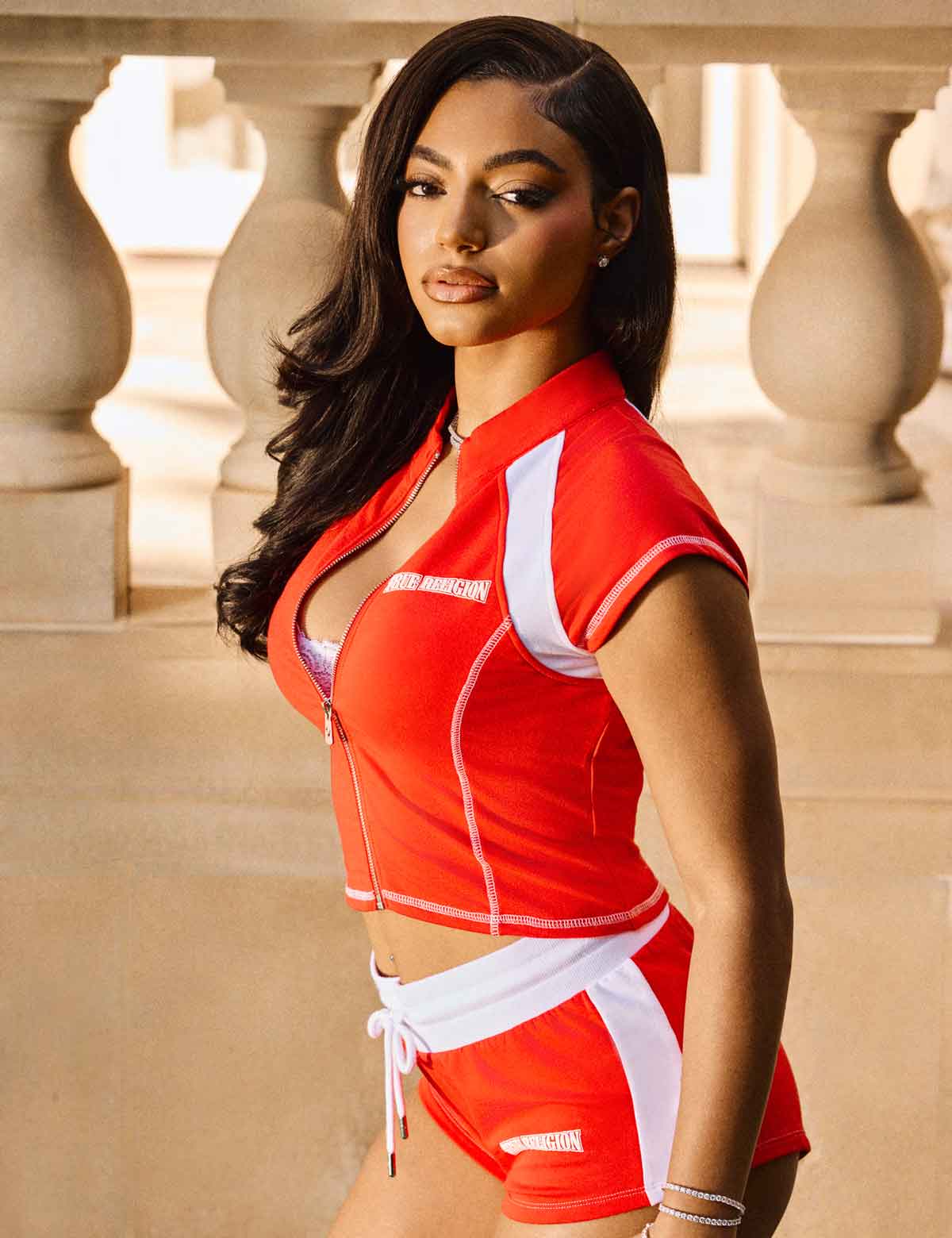 Woman wearing True Religion red and white sweat short set