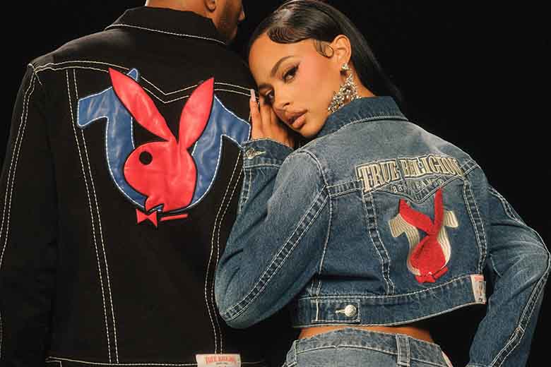 Two models wearing True Religion and Playboy collaboration denim outfits. The woman sports a cropped denim jacket and jeans with red Playboy bunny logos on the pockets, while the man wears a black denim jacket and jeans featuring bold embroidered Playboy and True Religion branding.