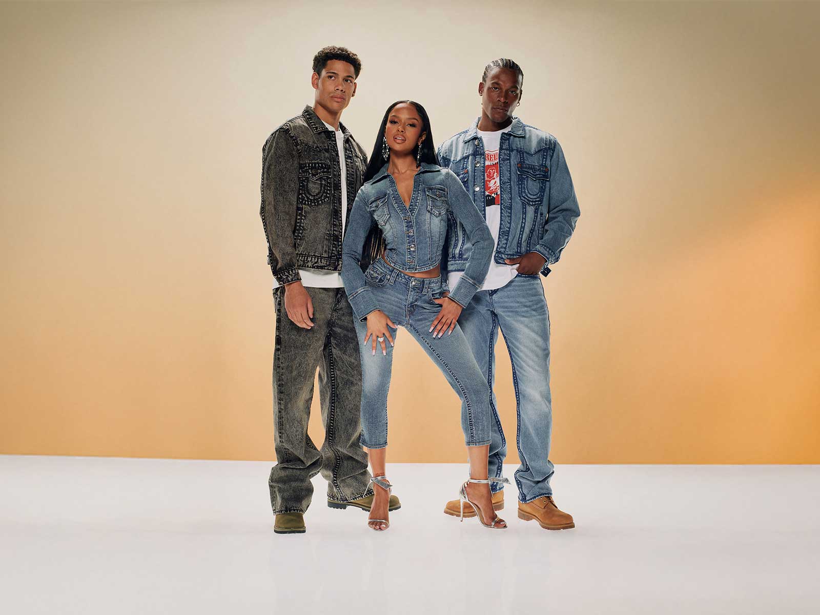 Models wear true religion light and dark wash jeans and jean jackets 